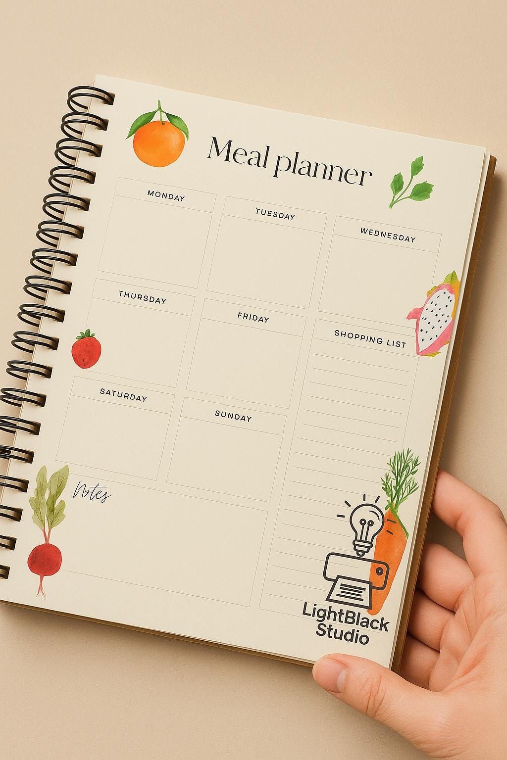 Notebook and kitchen tools laid out for weekly meal planning session